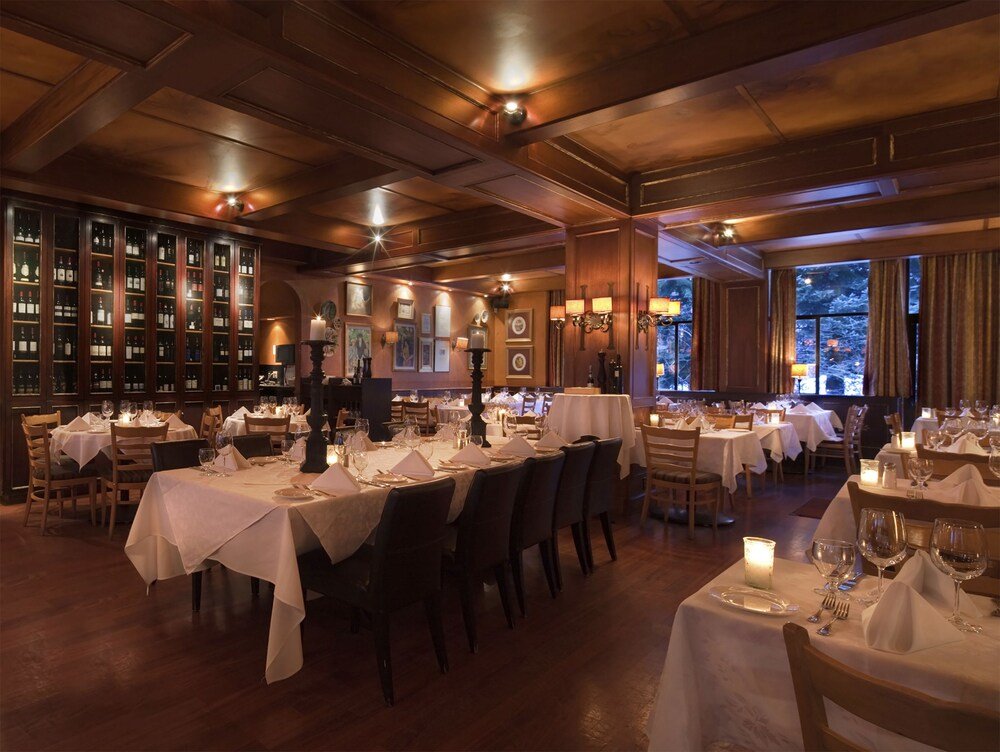 Restaurant with several tables at Mountain Side Hotel Whistler